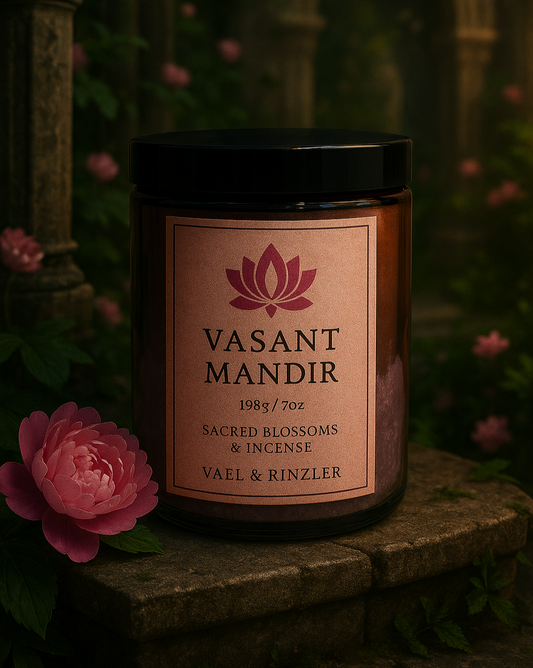 Vasant Mandir candle with a pink flower in the foreground